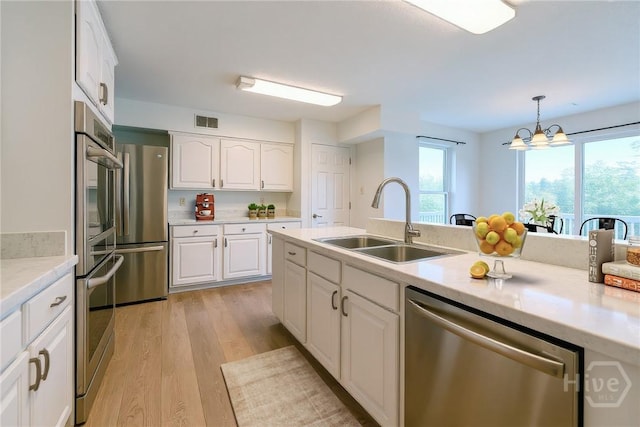 1 Shipyard Ln, Savannah, GA 31406 - kitchen featuring appliances with stainless steel finishes, a sink, light wood finished floors, and healthy amount of natural light
