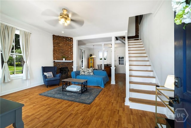 1402 Jefferson St, Savannah, GA 31401 - living room with ceiling fan, wood finished floors, a fireplace, and stairway