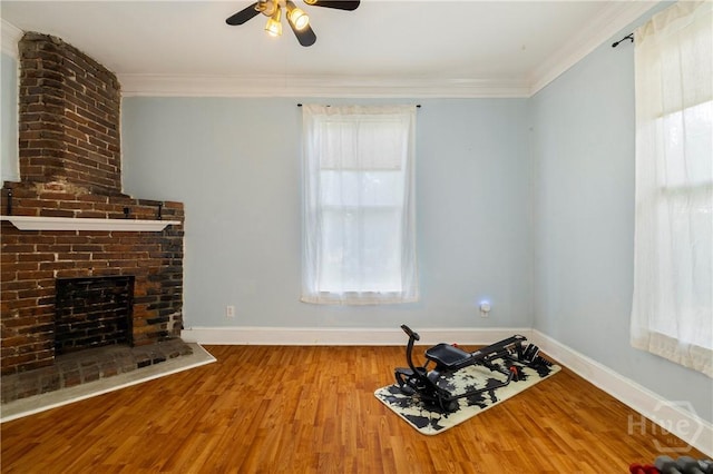1402 Jefferson St, Savannah, GA 31401 - unfurnished living room featuring a ceiling fan, baseboards, crown molding, wood finished floors, and a fireplace
