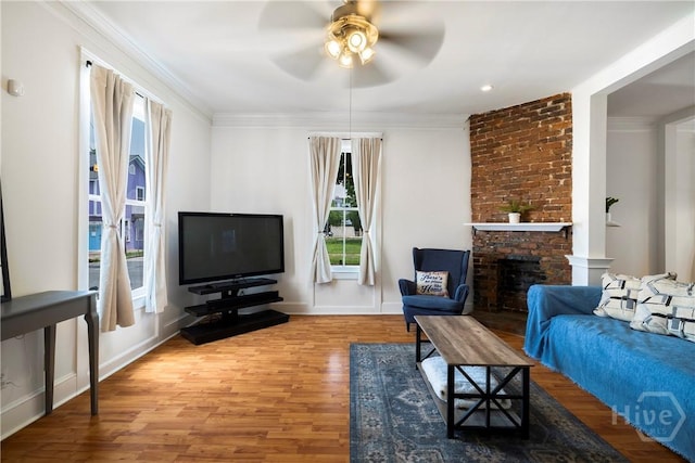 1402 Jefferson St, Savannah, GA 31401 - living room featuring a ceiling fan, wood finished floors, ornamental molding, and a brick fireplace