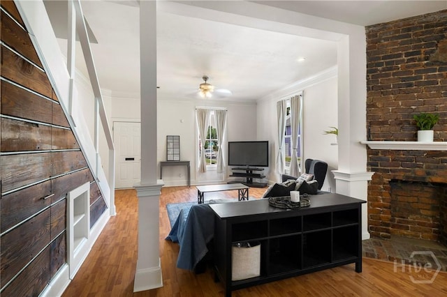 1402 Jefferson St, Savannah, GA 31401 - living room with crown molding, wood finished floors, decorative columns, and ceiling fan