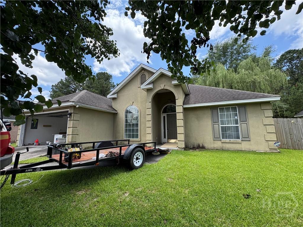 121 Cross Creek Dr, Pooler, GA 31322 - view of front facade with stucco siding, roof with shingles, and a garage