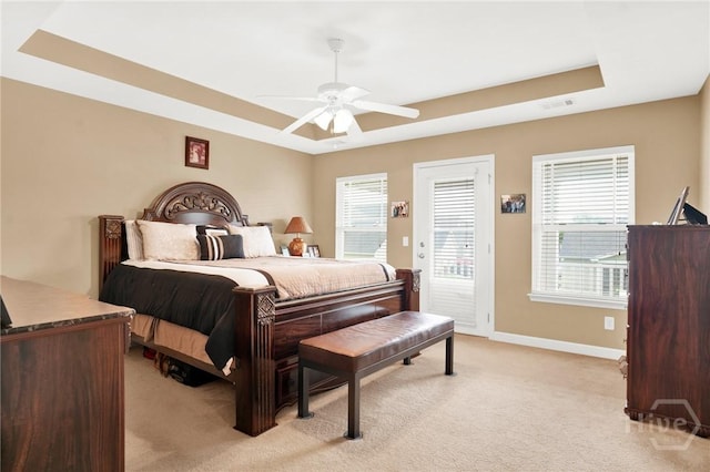 133 Moonlight Trl, Port Wentworth, GA 31407 - bedroom with a tray ceiling, light carpet, multiple windows, and access to exterior