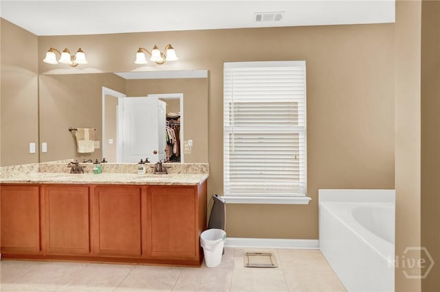 133 Moonlight Trl, Port Wentworth, GA 31407 - full bath with double vanity, baseboards, tile patterned flooring, a bath, and a spacious closet