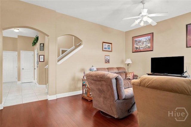133 Moonlight Trl, Port Wentworth, GA 31407 - living area with ceiling fan, arched walkways, wood finished floors, and baseboards