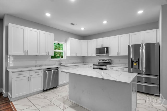 220 N Skinner Ave, Pooler, GA 31322 - kitchen with appliances with stainless steel finishes, light marble finish flooring, a sink, recessed lighting, and light stone countertops
