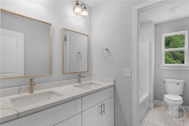 220 N Skinner Ave, Pooler, GA 31322 - full bathroom featuring double vanity, toilet, tile patterned flooring, baseboards, and bathing tub / shower combination