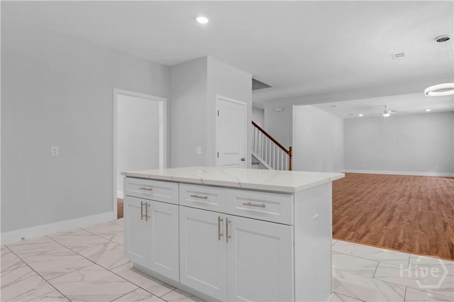 220 N Skinner Ave, Pooler, GA 31322 - kitchen featuring light marble finish flooring, light stone counters, white cabinetry, decorative light fixtures, and ceiling fan