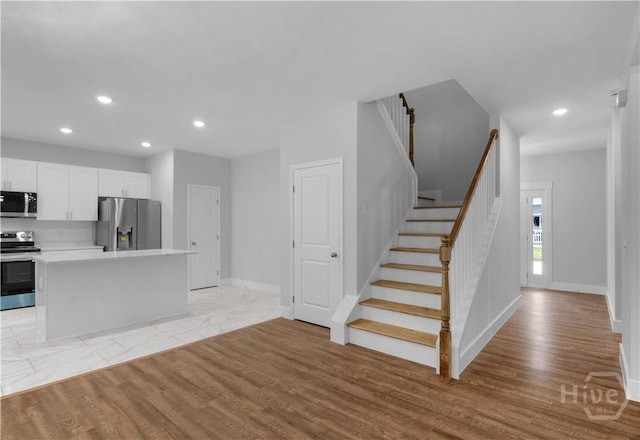 220 N Skinner Ave, Pooler, GA 31322 - unfurnished living room featuring stairs, recessed lighting, baseboards, and light wood-style floors