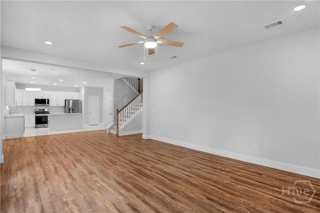 220 N Skinner Ave, Pooler, GA 31322 - unfurnished living room featuring light wood finished floors, stairway, baseboards, recessed lighting, and ceiling fan