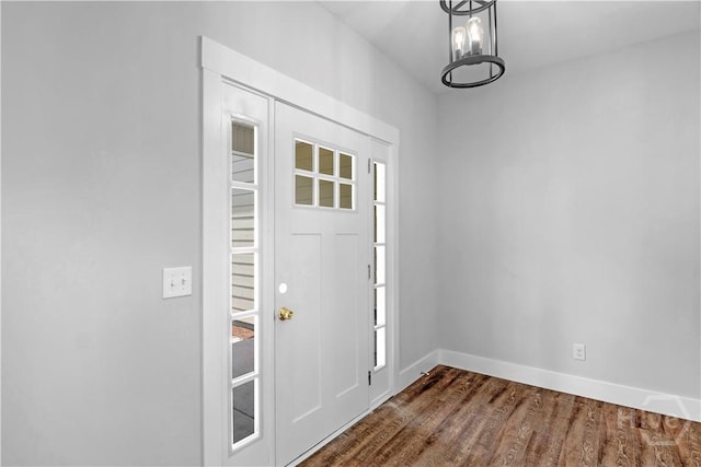 220 N Skinner Ave, Pooler, GA 31322 - foyer entrance with dark wood-style flooring, baseboards, and a chandelier