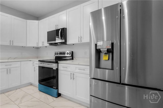 220 N Skinner Ave, Pooler, GA 31322 - kitchen featuring appliances with stainless steel finishes, light marble finish floors, white cabinets, and light stone counters