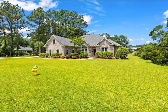 760 Southbridge Blvd, Savannah, GA 31405 - view of front of house with a front lawn, a chimney, and brick siding