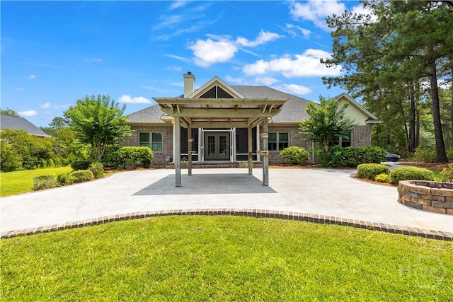 760 Southbridge Blvd, Savannah, GA 31405 - rear view of house featuring french doors, brick siding, a lawn, a patio, and a chimney