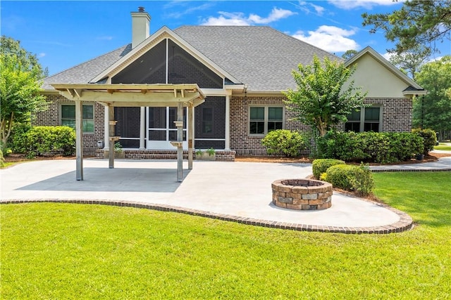 760 Southbridge Blvd, Savannah, GA 31405 - back of house featuring brick siding, a fire pit, a patio area, and a yard