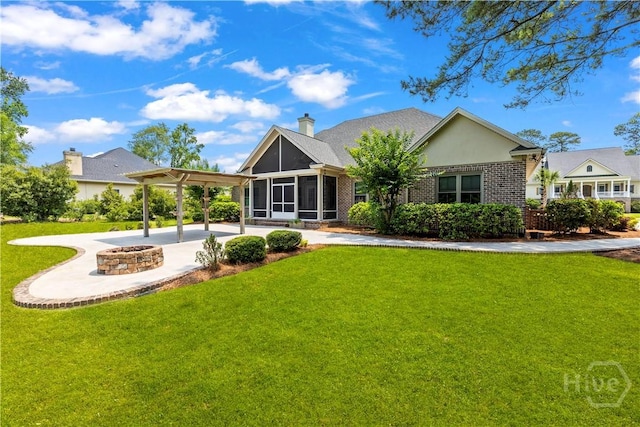760 Southbridge Blvd, Savannah, GA 31405 - back of house featuring a sunroom, a fire pit, a lawn, and brick siding
