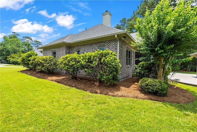 760 Southbridge Blvd, Savannah, GA 31405 - view of home's exterior featuring a yard, brick siding, a chimney, and roof with shingles