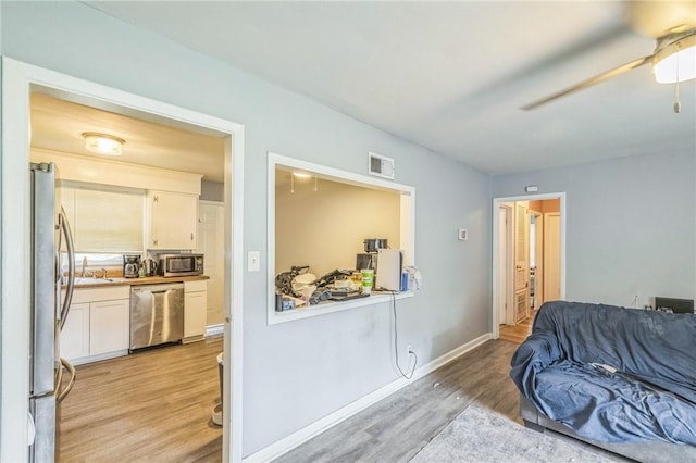 325 Bunting Dr, Savannah, GA 31404 - living area featuring light wood-style floors, ceiling fan, and baseboards