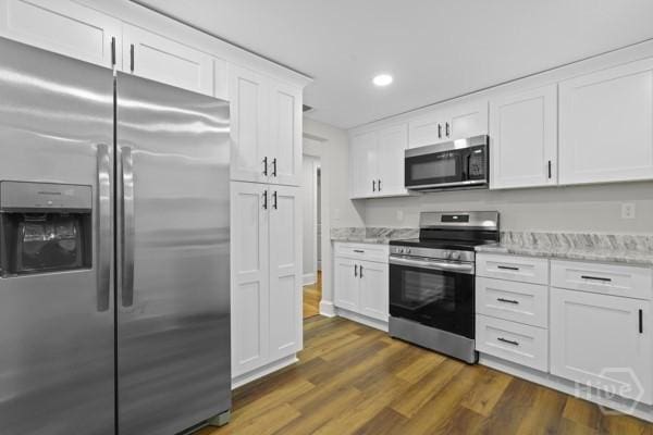 1817 Lloyd St, Savannah, GA 31405 - kitchen featuring appliances with stainless steel finishes, white cabinets, dark wood-type flooring, recessed lighting, and light stone countertops