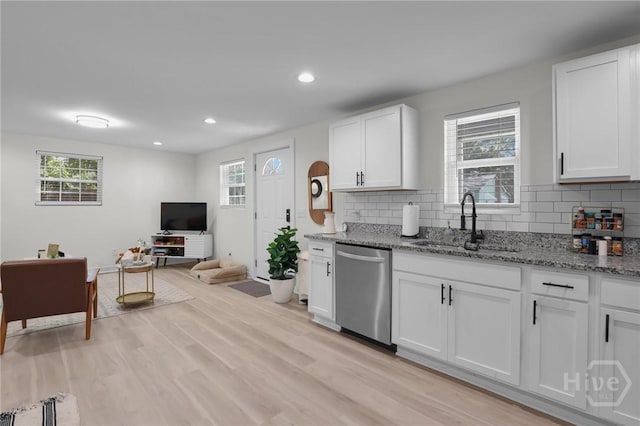 1220 E 69th St, Savannah, GA 31404 - kitchen featuring stainless steel dishwasher, a sink, light stone counters, decorative backsplash, and recessed lighting