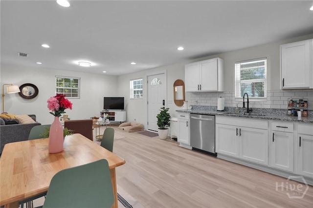 1220 E 69th St, Savannah, GA 31404 - kitchen featuring dishwasher, a sink, open floor plan, backsplash, and recessed lighting