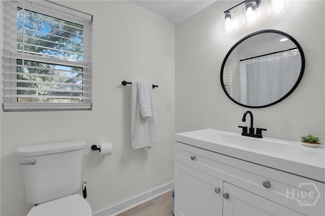 1220 E 69th St, Savannah, GA 31404 - full bath with vanity, baseboards, toilet, wood finished floors, and curtained shower