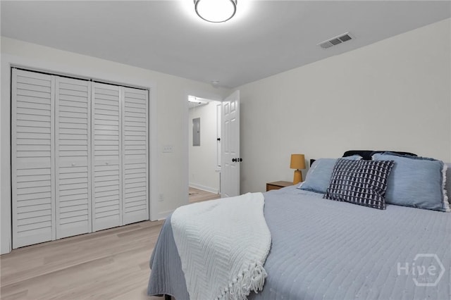 1220 E 69th St, Savannah, GA 31404 - bedroom with light wood-style flooring, a closet, and electric panel