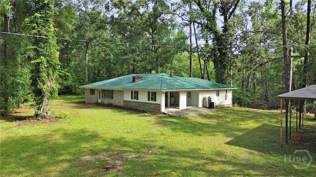 2317 Ga Highway 24, Statesboro, GA 30461 - back of house featuring a yard and a view of trees