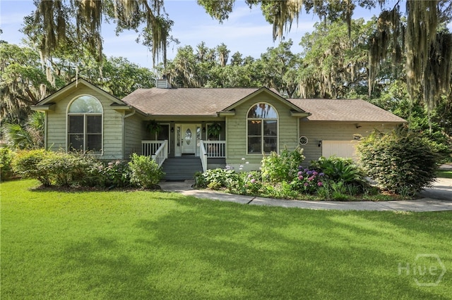 550 Strathy Hall Dr, Richmond Hill, GA 31324 - ranch-style home with a front yard, a porch, an attached garage, a chimney, and roof with shingles