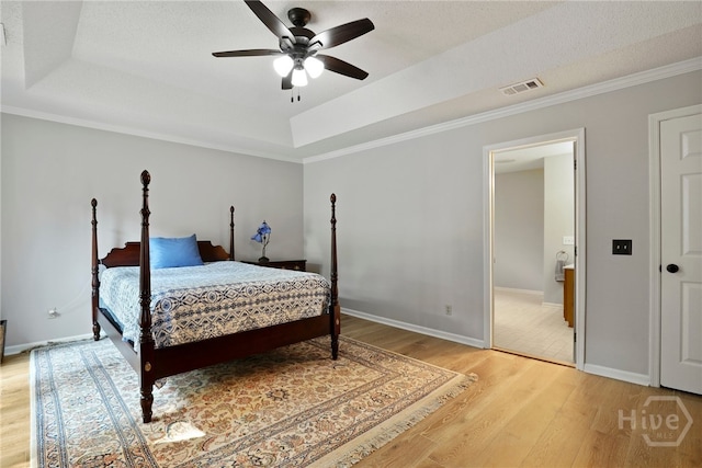 550 Strathy Hall Dr, Richmond Hill, GA 31324 - bedroom featuring light wood-type flooring, a tray ceiling, ornamental molding, and ceiling fan