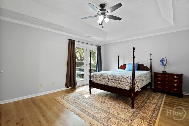 550 Strathy Hall Dr, Richmond Hill, GA 31324 - bedroom featuring a raised ceiling, access to outside, wood finished floors, baseboards, and crown molding