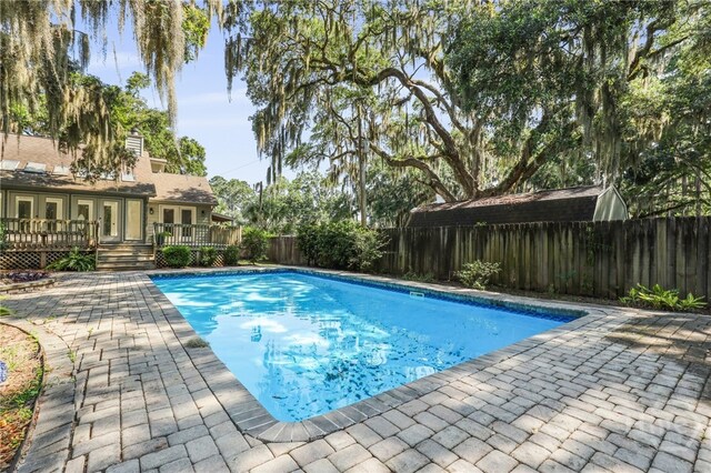 550 Strathy Hall Dr, Richmond Hill, GA 31324 - view of pool featuring a deck, a fenced backyard, french doors, and a patio area