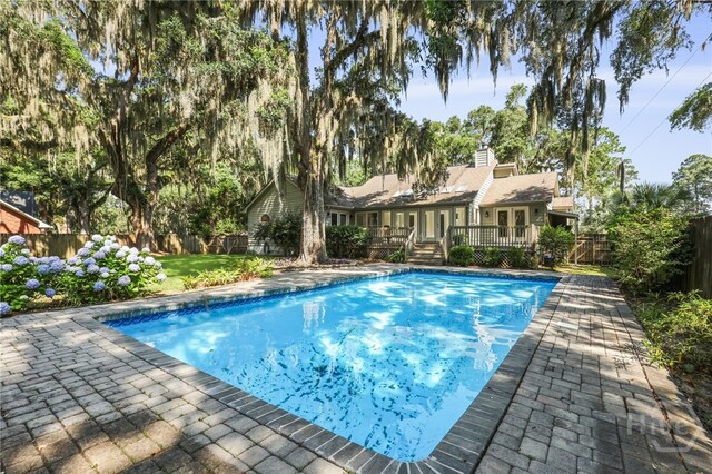 550 Strathy Hall Dr, Richmond Hill, GA 31324 - view of swimming pool with a wooden deck and a fenced backyard