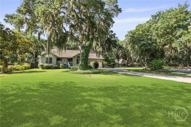 550 Strathy Hall Dr, Richmond Hill, GA 31324 - view of front of home with driveway, a front yard, and an attached garage