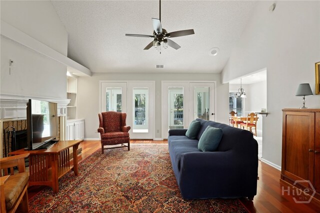 550 Strathy Hall Dr, Richmond Hill, GA 31324 - living room featuring lofted ceiling, wood finished floors, ceiling fan, a textured ceiling, and healthy amount of natural light