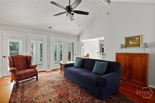 550 Strathy Hall Dr, Richmond Hill, GA 31324 - living room featuring wood finished floors, a ceiling fan, beamed ceiling, high vaulted ceiling, and a textured ceiling