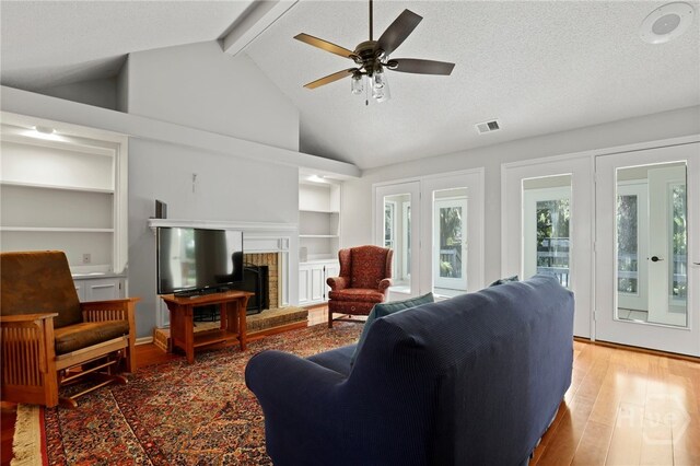 550 Strathy Hall Dr, Richmond Hill, GA 31324 - living area featuring wood finished floors, built in features, ceiling fan, and a fireplace
