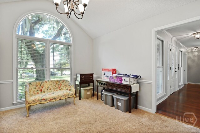 550 Strathy Hall Dr, Richmond Hill, GA 31324 - living area with a chandelier, vaulted ceiling, and carpet flooring