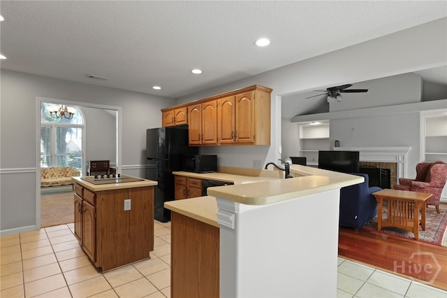 550 Strathy Hall Dr, Richmond Hill, GA 31324 - kitchen featuring a kitchen island, light tile patterned floors, light countertops, black appliances, and recessed lighting