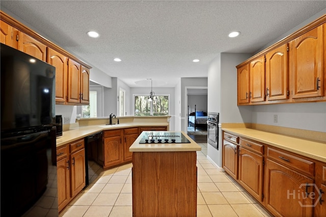 550 Strathy Hall Dr, Richmond Hill, GA 31324 - kitchen featuring black appliances, a kitchen island, a peninsula, light countertops, and recessed lighting