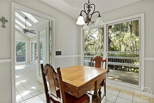 550 Strathy Hall Dr, Richmond Hill, GA 31324 - dining space with light tile patterned flooring, a chandelier, and lofted ceiling