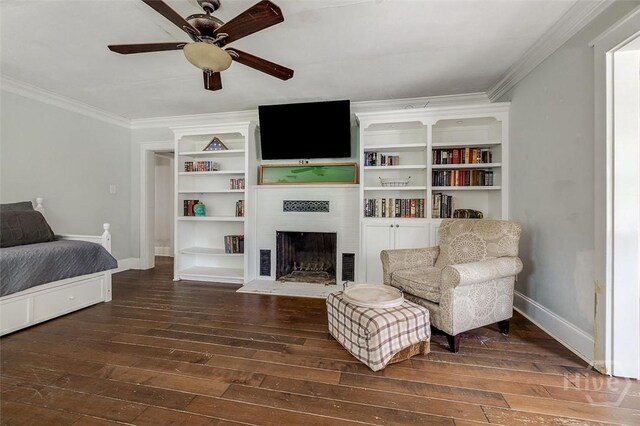 149 Spruce St, Richmond Hill, GA 31324 - living area with wood-type flooring, baseboards, ornamental molding, a fireplace with flush hearth, and a ceiling fan