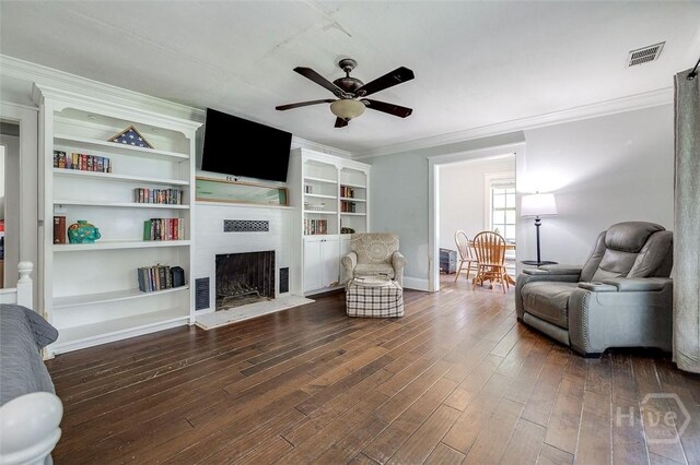 149 Spruce St, Richmond Hill, GA 31324 - living area with a ceiling fan, a fireplace, dark wood-type flooring, crown molding, and baseboards