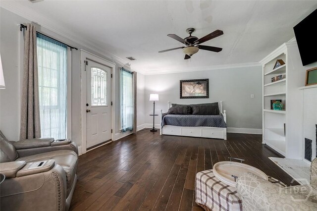 149 Spruce St, Richmond Hill, GA 31324 - living area featuring wood-type flooring, baseboards, ceiling fan, crown molding, and built in shelves