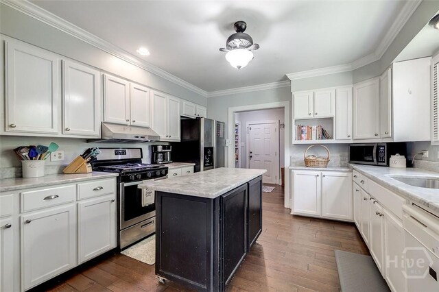 149 Spruce St, Richmond Hill, GA 31324 - kitchen featuring stainless steel appliances, under cabinet range hood, open shelves, crown molding, and white cabinetry