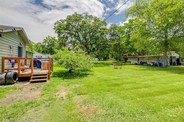 149 Spruce St, Richmond Hill, GA 31324 - view of grassy yard with a deck and view of wooded area