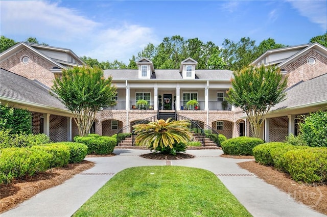 411 Southbridge Blvd Unit 706, Savannah, GA 31405 - view of front of home featuring stairs, brick siding, a porch, and a front lawn