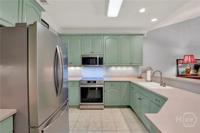 411 Southbridge Blvd Unit 706, Savannah, GA 31405 - kitchen with stainless steel appliances, a sink, green cabinetry, light countertops, and light tile patterned flooring