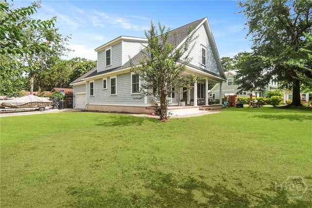 49 Tidewater Rd, Savannah, GA 31406 - back of property featuring covered porch, a lawn, and an attached garage