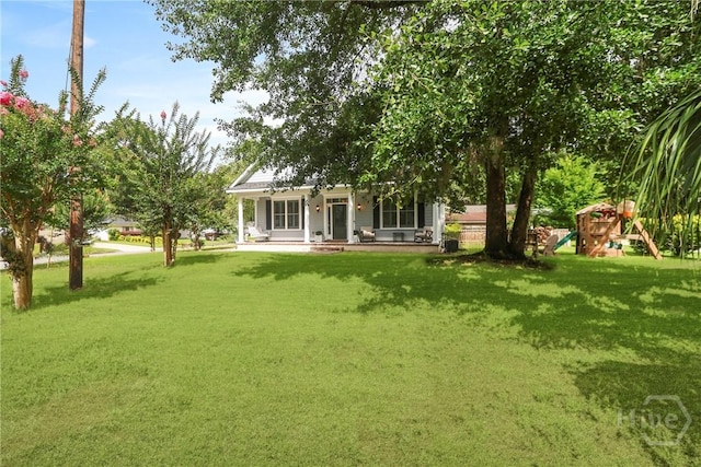 49 Tidewater Rd, Savannah, GA 31406 - view of green lawn with a porch and a playground